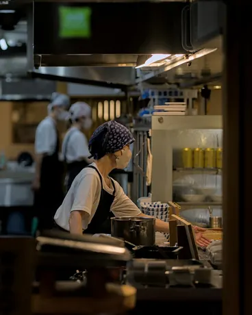 Chefs at work in a busy restaurant kitchen during service